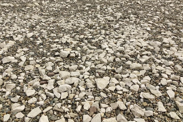 Perspectief zicht op de rotsachtige Pebble oppervlak, Stone achtergrond — Stockfoto