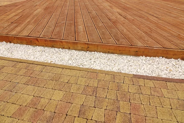 Composite Wood Decking, White Marble Gravel And Stone Brick Pavi — Stock Image Composite Wood Decking, White Marble Gravel And Stone Brick Pavi Stock Photo
