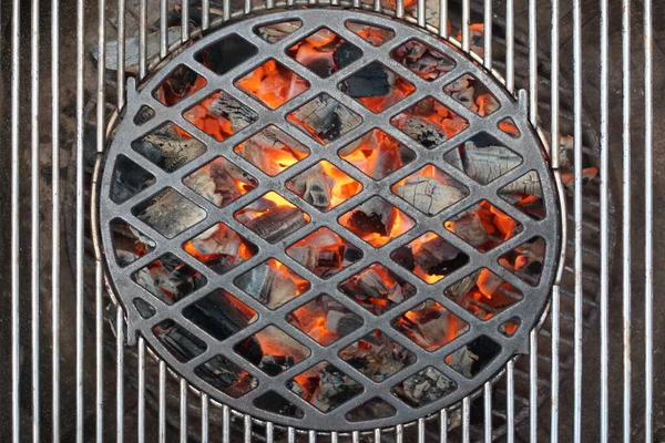 Kettle Grill Pit With Flaming Charcoal. Top View Of BBQ Hot Kettle Grill With Cast Iron Grid, Isolated Background, Overhead View. Barbecue Kettle Grill On Summer Backyard Ready Grilling Cookout Food.