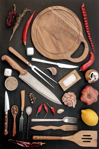 Handy Cooking Tool. Many Cookware Items And Spices Isolated on Black Background. Large Group of Cookware Tolls on Table. Collection of Kitchen Utensils. Cooking and Serving Utility and Spices.