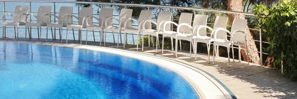 Outdoor Hotel Or Villa Or Apartments Terrace With Outside Pool And White Chairs. Swimming Pool On Mountains Park Terrace With High Above Sea View.