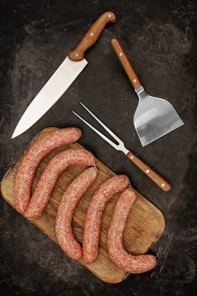 2016 Sausages Old Wooden Cutting Board Grill Tools Black Table — 스톡 사진