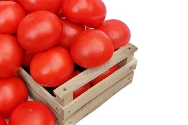 Many tomatoes in wooden box — Stock Photo, Image