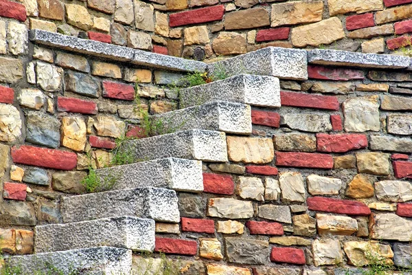 Old White Stone Stairs and multicolored Stonework Wall