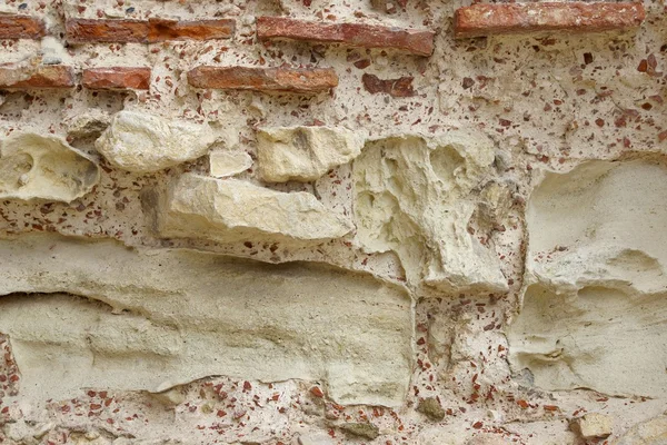 Vecchio ruvido muro di pietra rossa e bianca — Foto Stock