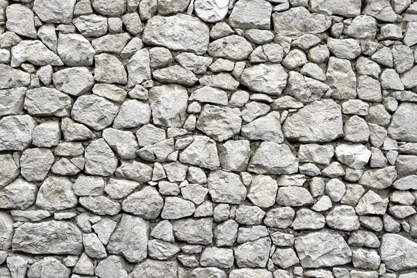 Stenen muur met willekeurig betegelde patroon — Stockfoto