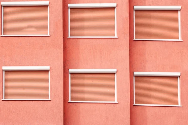 Red Building Facade with Six Closed Windows Shutters — Stock Photo, Image