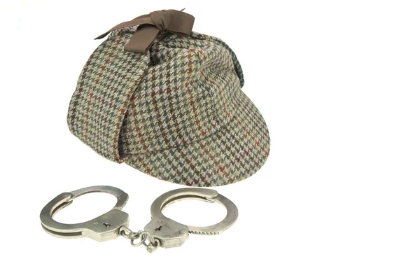 Deerstalker Hat and Real Steel Handcuffs — Stock Photo, Image
