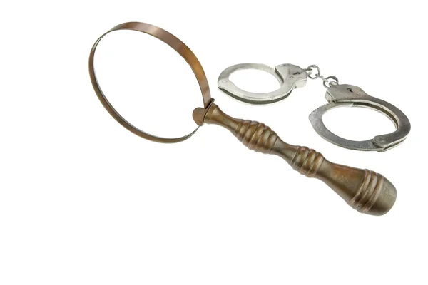 Retro Magnifying Glass and Handcuffs — Stock Photo, Image