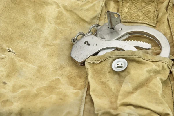 Handcuffs in The Camouflage Army Pants Pocket or Haversack — Stock Photo, Image