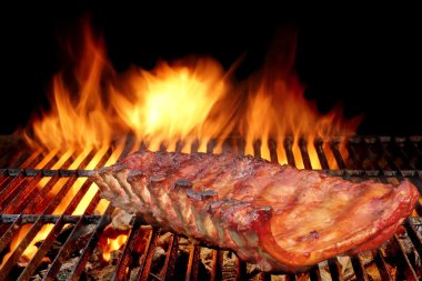 BBQ Baby Back Pork Ribs On The Hot Flaming Grill clipart