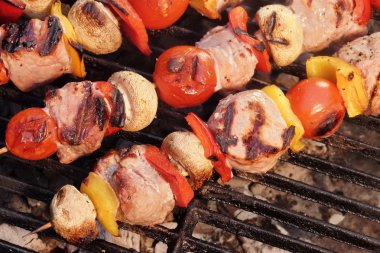 Pork And Vegetables Skewers Cooking On BBQ Grill clipart