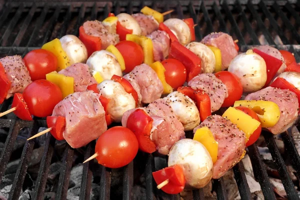 Brochetas de cerdo y verduras cocinando en la parrilla barbacoa — Foto de Stock