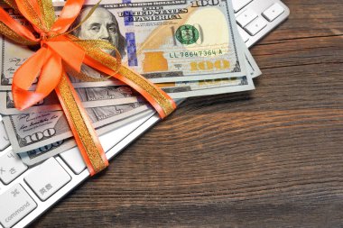 Money Tied With A Ribbon On The Keyboard clipart