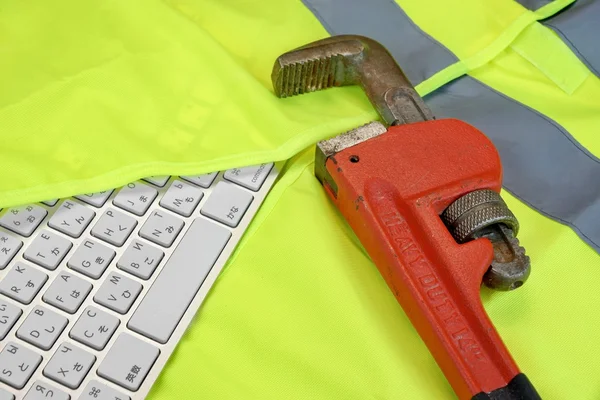 Keyboard In The Yellow Reflective Safety Vest And Wrench — Stockfoto