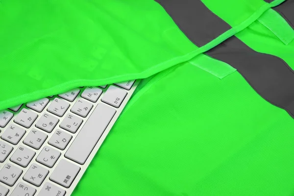 Keyboard In The Green Reflective Safety Vest — Stockfoto