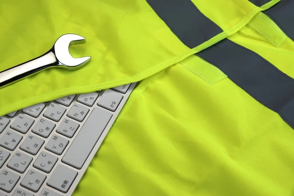 Keyboard In The Yellow Reflective Safety Vest And Wrench — Stok fotoğraf