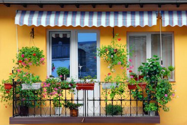 Yellow Building Wall With Balcony Flowery Garden clipart