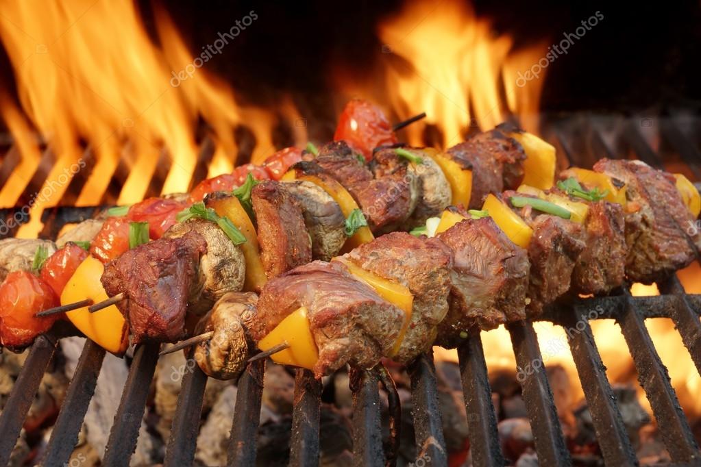 Beef Kebabs With Paprika Slice On The BBQ Flaming Grill Stock Photo by
