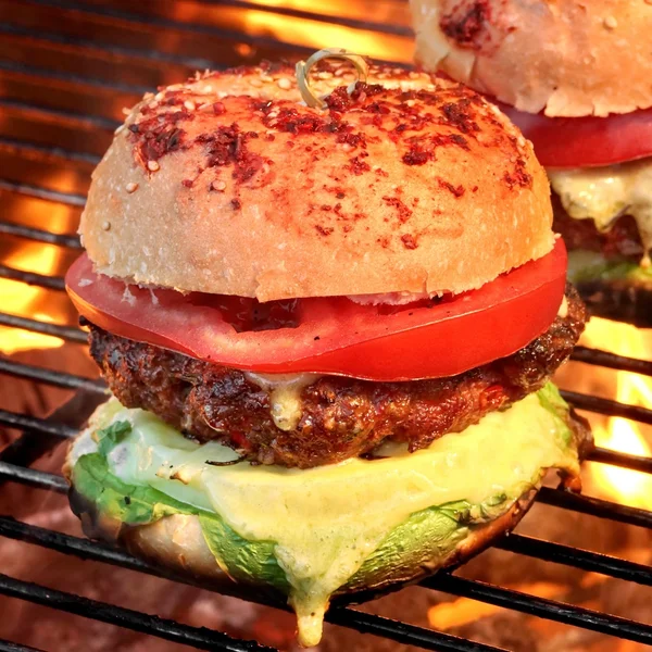 Cheeseburgers caseiros no churrasco quente flamejante — Fotografia de Stock