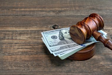 Judges or Auctioneer Gavel And Money On The Wooden Table clipart