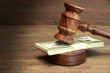 Bundle Of Money, Judges Gavel And Soundboard On Wooden Table clipart