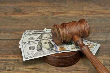 Bundle Of Money, Judges Gavel And Soundboard On Wooden Table clipart
