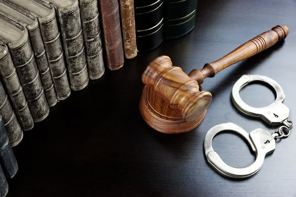 Judges Gavel, Handcuffs And Old Book On The Black Table — Stock Fotó