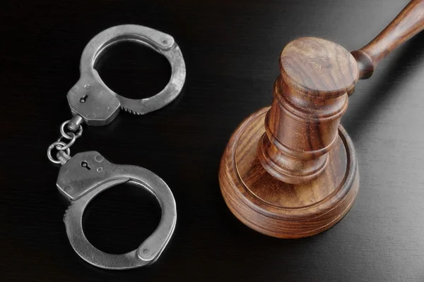 Real Judges Gavel And Handcuffs On The Black Table Royalty Free Stock Images