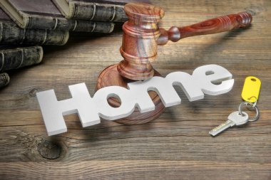 Sign Home, Key, Judges Gavel And Book On Wood Table clipart