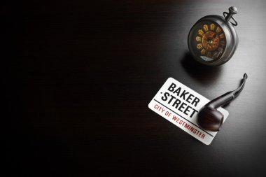 Baker Street Sign And Sherlock Holmes Symbol On Black Table clipart