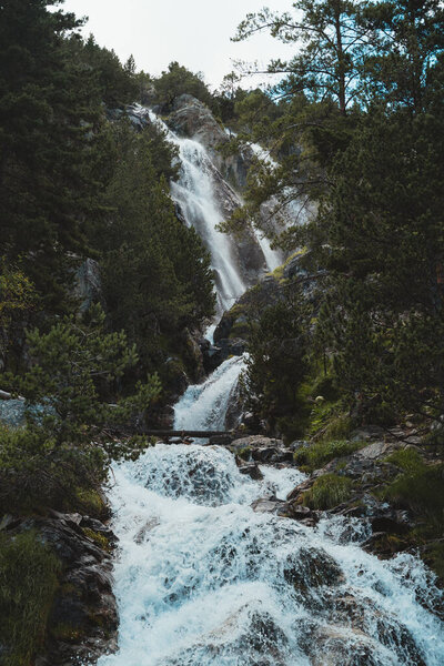 Wild waterfall in a forest in Tena Valley