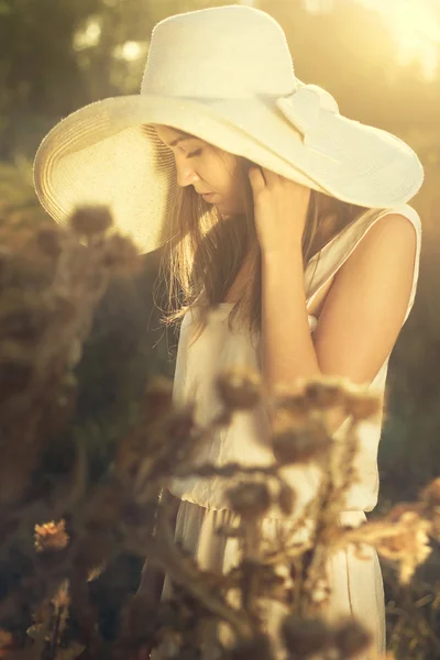 Beautiful girl in a hat looking sadly — Stock Photo, Image