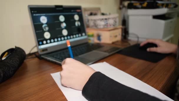Gaucher fille tout en faisant intelligent école leçon vidéo appel sur un ordinateur portable, covid-19 pandémie de maladie, isolement social — Video
