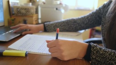 Young woman studying at home while use notebook for online lesson video call,covid-19 pandemic distant learning