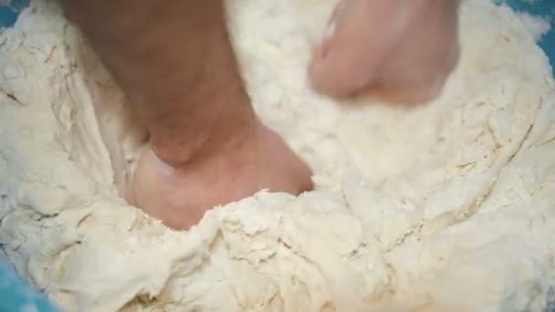 Close up view of man hand while kneading tough to prepare homemade bread at home — стоковое видео