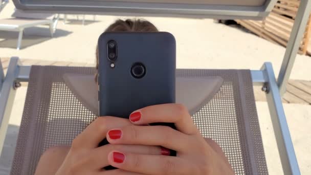 Young Woman use smartphone for chatting on a beach in summer time,social network tech addiction — Wideo stockowe