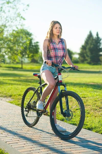 Girl sitting on bicycle — Stock Photo, Image