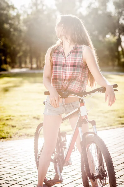 Girl sitting on bicycle — Stock Photo, Image
