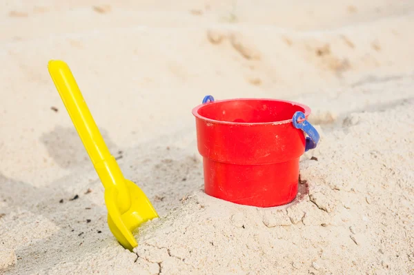 Red bucket and yellow spade — Stock Photo, Image