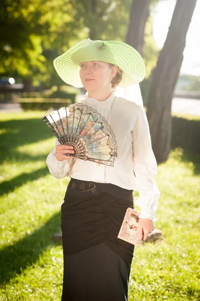 Frau mit Ventilator im Park — Stockfoto
