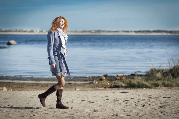 Red-haired girl on the bank of river — Stock Photo, Image