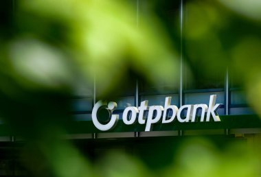 Bucharest, Romania -  June 28, 2020: A logo of the Hungarian bank branch OTP Bank, is displayed above the entrance of a building, in Bucharest, Romania. clipart