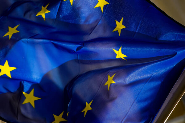 Bucharest, Romania - January 25, 2021: The flag of Europe is seen waving in the wind on a pole in Bucharest.