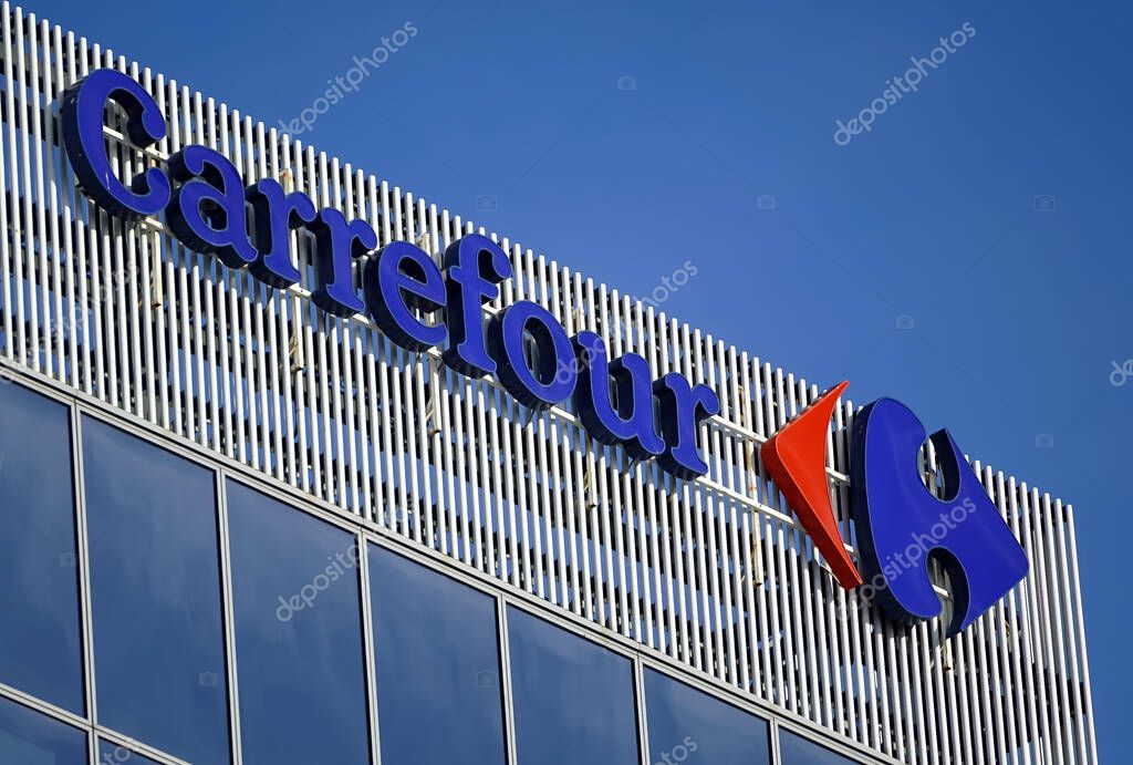 Bucharest, Romania - January 21, 2021: The logo of the French multinational retailer Carrefour is seen on top of Green Court Building B, in Bucharest. This image is for editorial use only.