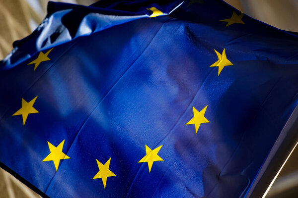 Bucharest, Romania - January 25, 2021: The flag of Europe is seen waving in the wind on a pole in Bucharest.