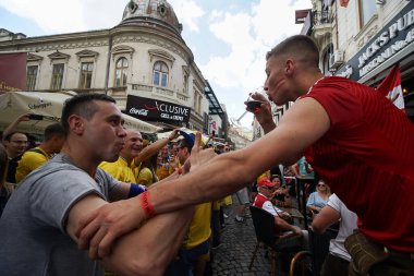 Bükreş, Romanya - 21 Haziran 2021: Ukrayna ve Avusturya partisini destekleyenler, EURO 2020 grup safhasında Ukrayna ile Avusturya arasında oynanan futbol karşılaşması öncesinde eski kentin barlarında ve sokaklarında toplandılar..