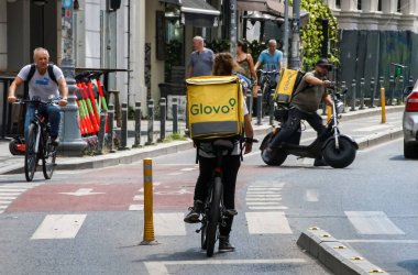 Bükreş, Romanya - 12 Ağustos 2021: Glovo gıda dağıtım kuryeleri Romanya 'nın Bükreş kentinde gıda dağıtımı yapıyorlar.