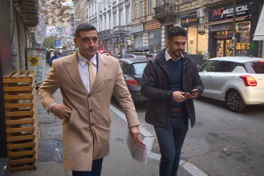 Bucharest, Romania. 14th Nov, 2025: George Simion (L), president of Alliance for the Union of Romanians (AUR), leaves accompanied by an unidentified person after attending the submission of Anca Alexandrescu's candidacy for the position of general ma