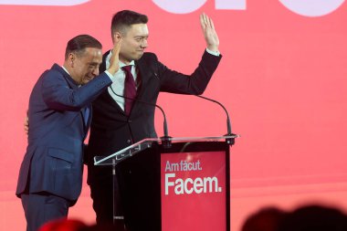 Bucharest, Romania. 19th Nov, 2025: Daniel Baluta (L), mayor of Sector 4, and Andrei Trocan (R), deputy mayor of Sector 4, wave to the audience during the launch of the candidacy of Baluta for general mayor of Bucharest.